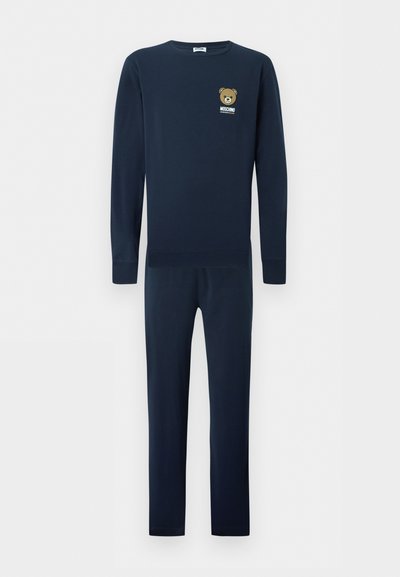 Σετ μπλουζάκι με μακριά μανίκια και παντελόνι σε ναυτικό μπλε χρώμα με μικρό λογότυπο αρκούδου και το κείμενο «Moschino Underwear» στο στήθος.