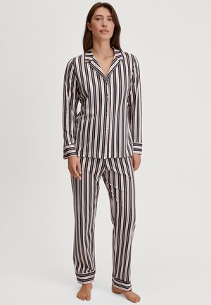 Striped pajama set featuring long sleeves and pants. Made from soft fabric with vertical black, red, and white stripes; button closure on shirt.