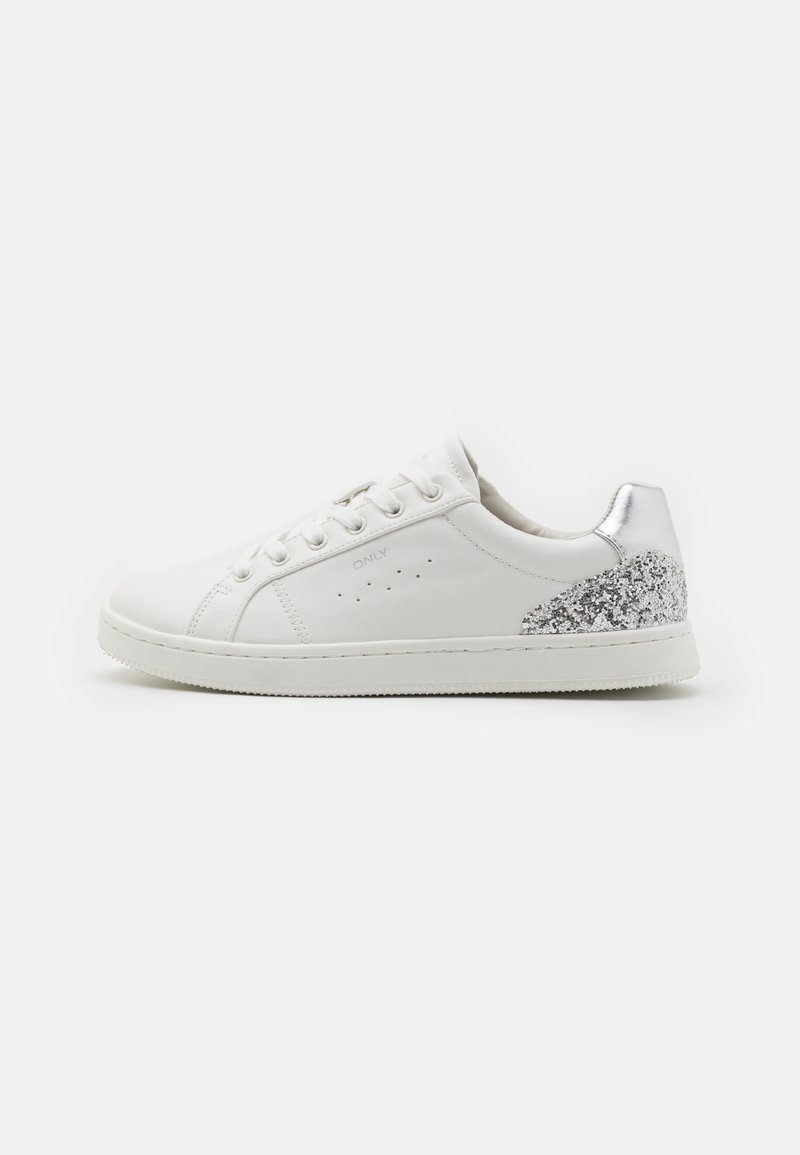 White leather sneaker with silver glitter accent on the heel, textured surface, round toe, and six-eyelet lace-up design.