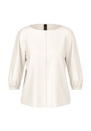 Cream-colored blouse with three-quarter puffed sleeves, round neckline, and a vertical seam down the center front.
