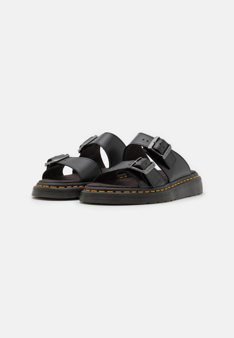 Black leather sandals with two adjustable buckles, open toe, and a textured footbed. Features a thick, textured sole with orange stitching.