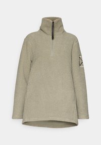 Pullover in fleece di un verde oliva chiaro, con colletto alto, chiusura a mezza zip e tessuto testurizzato. Decorato con una toppa geometrica sulla manica.