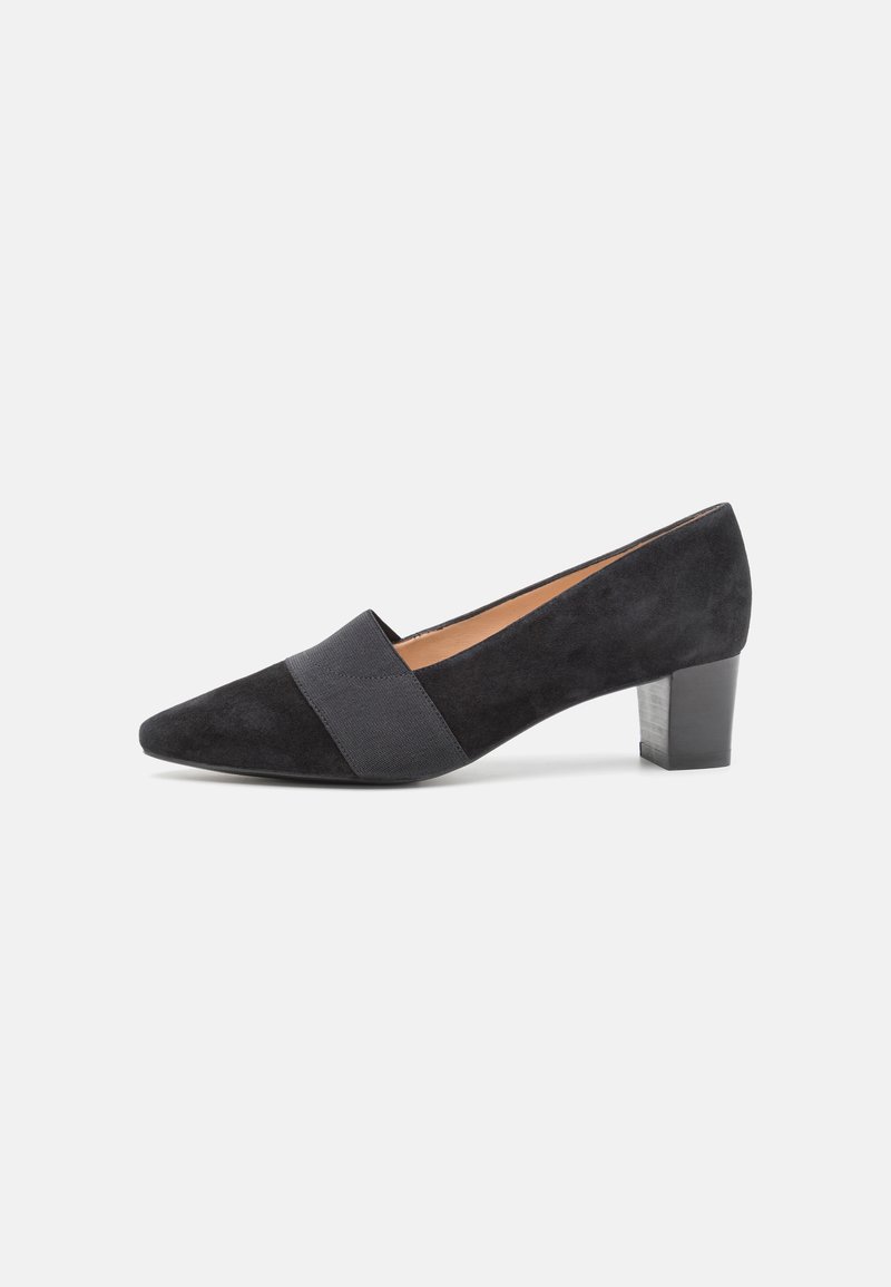 Black suede pump featuring a pointed toe, contrasting elastic band across the vamp, and a medium block heel. Smooth texture with subtle shine.
