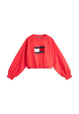 Red long-sleeve cropped sweatshirt with ribbed cuffs and Tommy Hilfiger logo patch in the center front.