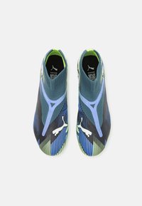 Athletic shoes featuring a black, blue, and green textile upper, slip-on design, and contrasting white logo accents.