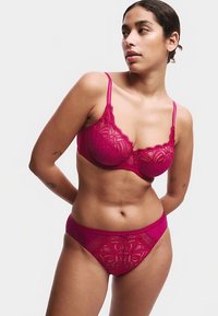 Fuchsia Spitze Dessous-Set mit einem gemusterten BH mit verstellbaren Trägern und passenden transparenten Panties mit Blumenstickerei.