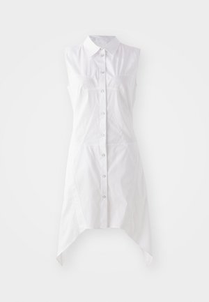 Hvid ærmeløs kjole med kraveudskæring, frontlukning med knapper, to brystlommer og en asymmetrisk kant. Lavet af vævet stof.