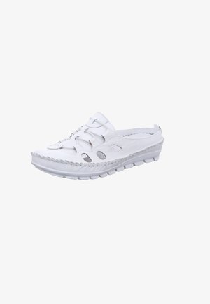 White slip-on shoe made of leather with cut-out detailing, textured stitching, and a flexible rubber sole with a distinctive tread pattern.