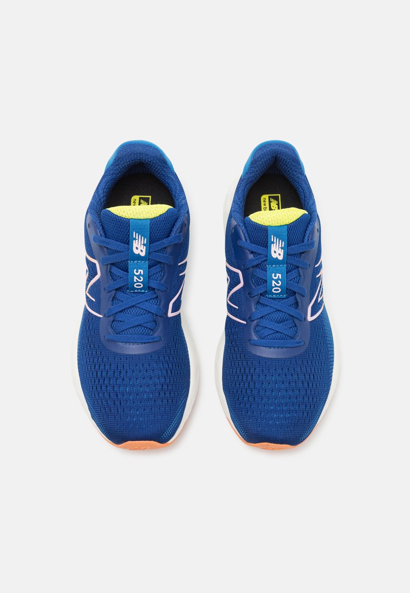 Zapatillas deportivas de malla azul con parte superior texturizada. Las características incluyen una suela exterior naranja, una entresuela blanca y un prominente logo "NB" en el lateral.