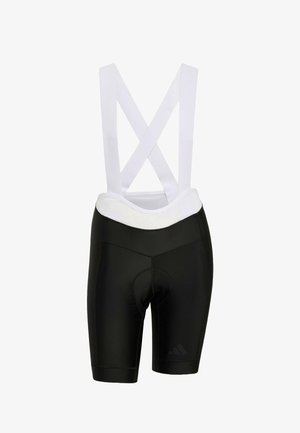 Shorts de cyclisme noirs avec bretelles blanches croisées, zone de siège rembourrée, texture lisse et détail de logo subtil en bas à gauche.