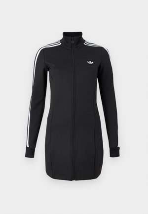 Juoda sportinė striukė su užtrauktuku, pagaminta iš lygaus audinio, su baltomis juostelėmis ant rankovių ir mažu logotipu ant krūtinės.