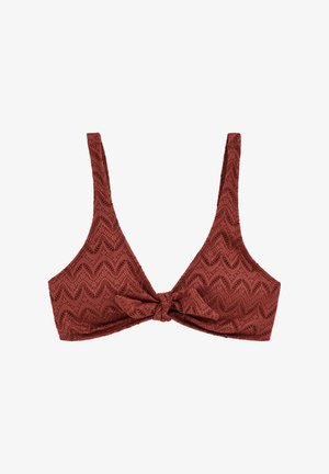 Haut court en couleur rouille foncée avec motif en dentelle en zigzag et détail noué au centre devant, doté de larges bretelles.