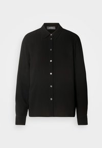 Black, long-sleeve shirt with a button-down collar and front button closure. Features a textured fabric with vertical stripes.