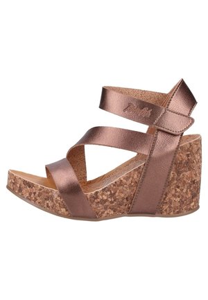 Sandały na korkowej koturnie z bronzowymi metalicznymi paskami. Posiadają krzyżujące się paski i teksturowaną bazę korkową. Gładkie, błyszczące wykończenie pasków.