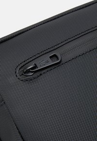 Lacoste NAOS UNISEX - Jostas soma - noir