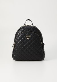 Sac à dos en cuir matelassé noir avec quincaillerie dorée, doté d'une poche zippée à l'avant et d'un détail de logo triangulaire. Forme arrondie et poignée supérieure.