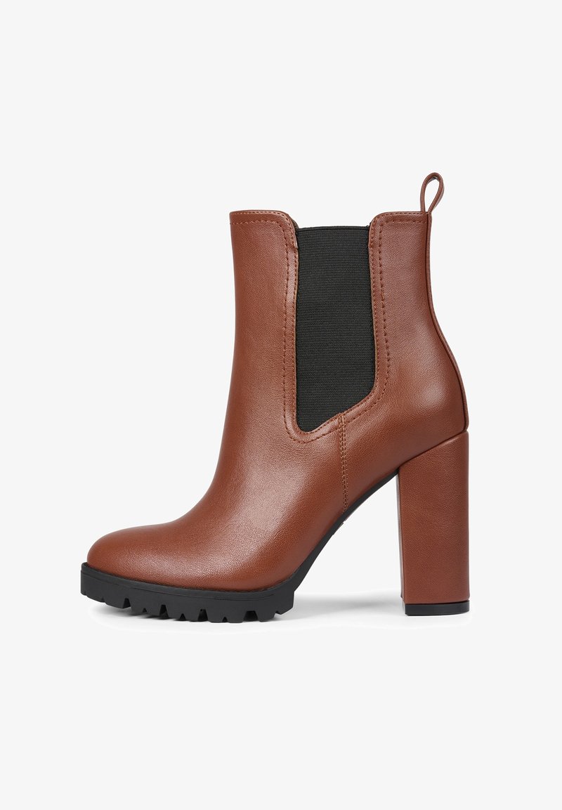 Brown leather ankle boot with black elastic side panel, high block heel, rounded toe, and textured rubber sole for grip.