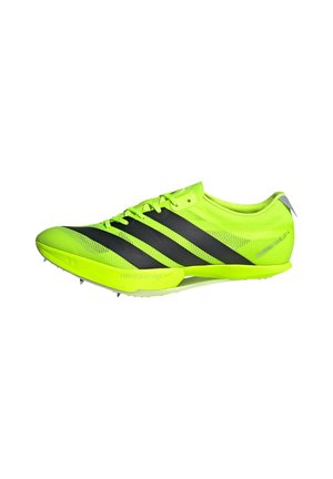 Lightweight yellow and black athletic shoe with a mesh upper, three signature black stripes, and rubber spikes on the outsole for traction.
