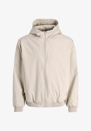 Svetlo bež kapucar z zadrgo spredaj, z elastičnimi manšetami in spodnjim robom; ima gladek, mat tkanino z enostavno zasnovo.