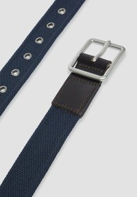 Marine canvasriem met een zilverkleurige metalen gesp, voorzien van een leren accent en ronde oogjes langs de lengte voor verstelbare maat.