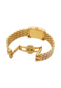 Correa de reloj de metal en tono dorado con cierre abierto, mostrando la parte trasera cuadrada del reloj y detalles multicolor en un eslabón en un lado.