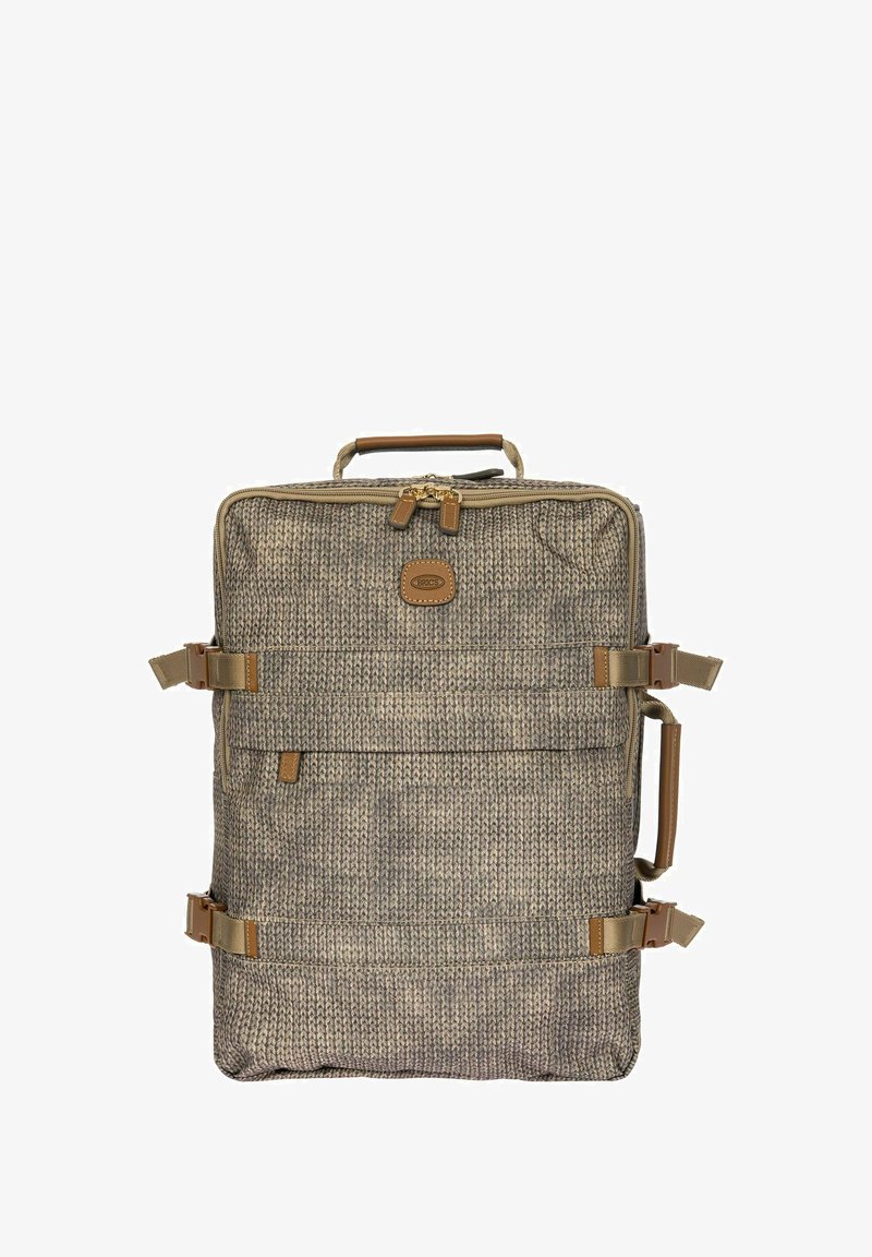 Sac à dos en tissu texturé beige et marron, avec des accents beige, deux sangles latérales réglables et une poignée supérieure pour le transport.