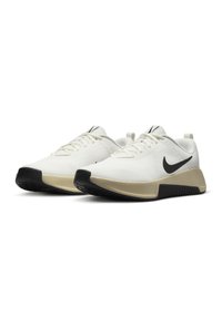 White athletic shoes with a textured upper, black accents, and a beige sole. Features a cushioned heel and lace-up design.