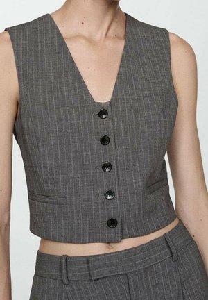 Sleeveless gray pinstripe vest with black buttons worn over matching high-waisted pinstripe trousers on a person.