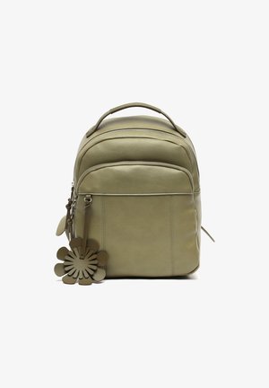 Compact olive green leather backpack with front pocket, top handle, zipper closures, and a flower-shaped leather keychain accessory.