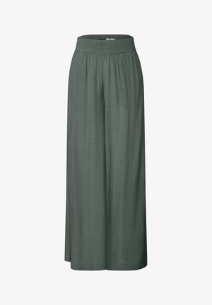 Lange, brede bukser i mørkegrøn stof. Har en elastisk talje og en glat tekstur. Ingen synlige mønstre eller hardwaredetaljer.