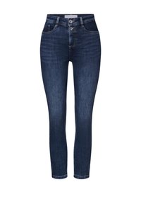 Mörkblå jeans i skinny-modell med hög midja, fem fickor och stängning med två knappar. Texturerat tyg med lätt slitningar.