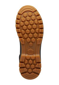Rubberen schoenzool met een hexagonaal patroon in bruin, met gleuven voor grip, en een logo in het midden. Gestructureerd oppervlak voor meer grip.
