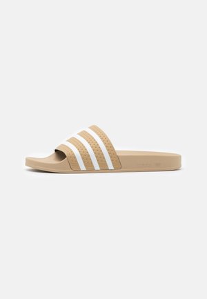 Beige Slide-Sandale mit strukturierten weißen drei Streifen über dem Riemen, offenem Zehenbereich und flacher Sohle.