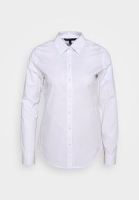 Camicia bianca a maniche lunghe con chiusura a bottoni, colletto e orlo curvo. Realizzata in tessuto morbido con un taglio classico e senza motivi visibili.
