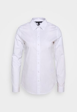 Camicia bianca a maniche lunghe con chiusura a bottoni, colletto e orlo curvo. Realizzata in tessuto morbido con un taglio classico e senza motivi visibili.