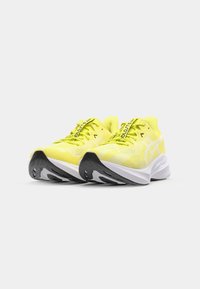 Neon yellow running shoes featuring a mesh upper, black rubber sole, and white midsole, with patterned accents and contrasting laces.