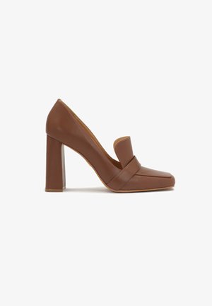 Brown leather high-heeled shoe with a square toe and a wide strap across the front. The heel is block-shaped and solid.
