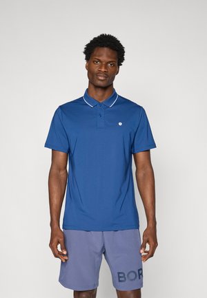 Blue polo shirt with a buttoned collar and white trim, featuring a small logo on the left chest. Worn with gray shorts displaying the word "BOR."
