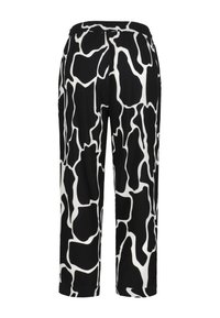 Pantalons à motif noir et blanc avec une taille élastique, présentant un design abstrait ressemblant à des impressions animales, d'une longueur courte, et en tissu lisse.