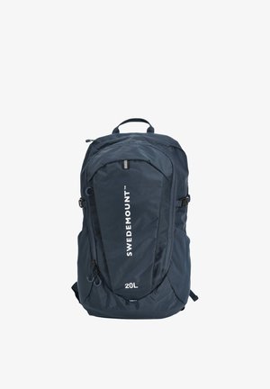 Sac à dos Swedemount bleu marine de 20 litres avec poche avant zippée, sangles de compression latérales et poignée de transport supérieure sur fond blanc.