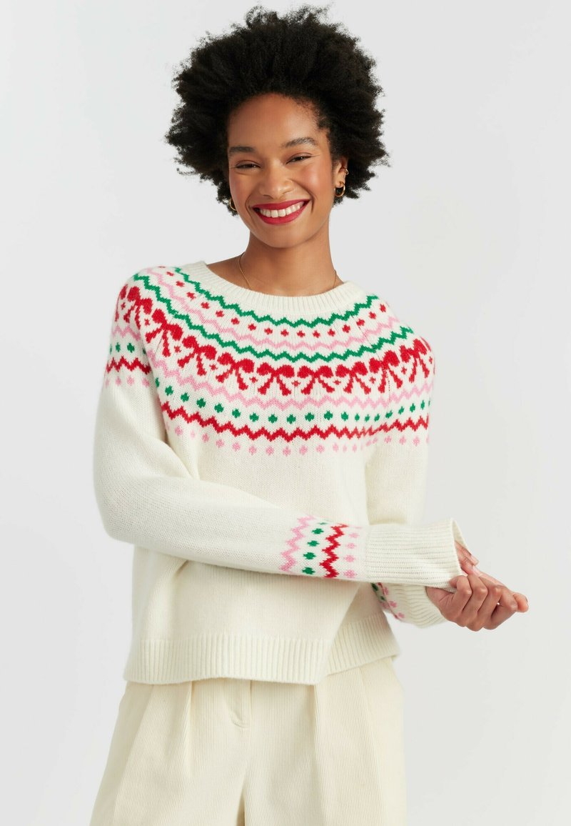 Cream-colored sweater with a patterned yoke in red, green, and pink. Features long sleeves and ribbed cuffs with geometric accents.
