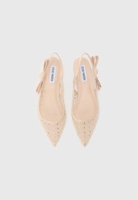 Nude slingback flats with pointed toes, adorned with silver studs. Features a bow accent and sheer side panels for a delicate design.