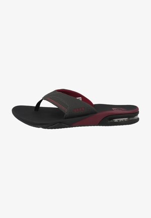Black and burgundy flip-flops with a cushioned sole, textured straps, and a clear air cushion detail on the heel for added comfort.
