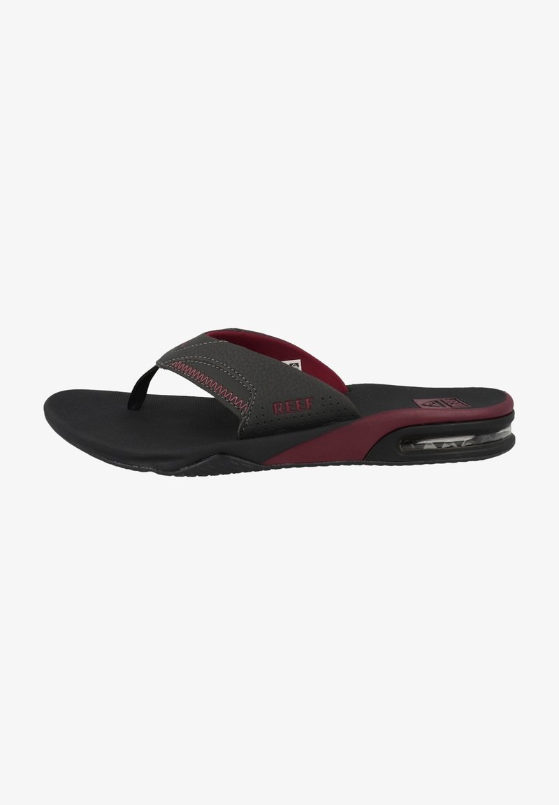 Black and burgundy flip-flops with a cushioned sole, textured straps, and a clear air cushion detail on the heel for added comfort.