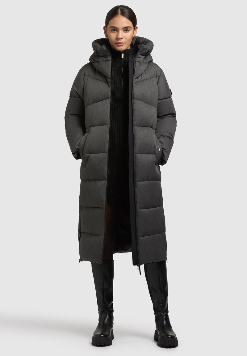 Padded long coat in dark gray, featuring a hood, vertical quilting, two front pockets, and a full-length zipper. Smooth texture.