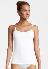 White camisole with thin straps, made from smooth, stretchy fabric. Features a fitted design and a round neckline without additional embellishments.