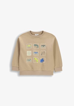 Beżowa dziecięca bluza z dziewięcioma kwadratowymi naszywkami przedstawiającymi kolorowe ciężarówki, różne dinozaury oraz napisami "Create Explore Conquer Repeat."