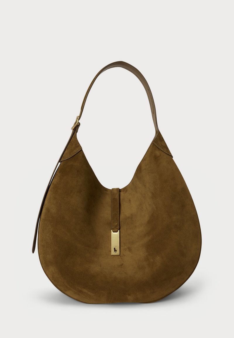 Brūna zamša hobo soma ar izliekto formas, vienu plecu siksnu un zeltītu aizdari priekšpusē. Gluda tekstūra, minimālisma dizains.