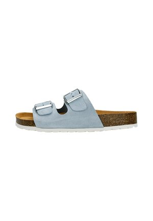 Light blue suede slide sandal with dual adjustable metallic buckles, cork midsole, and textured white rubber outsole.