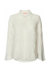 Chemisier blanc à manches longues avec fermeture à boutons, tissu texturé avec des rayures verticales et des accents de broderie florale à l'avant.